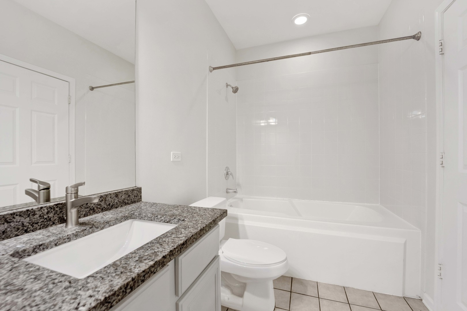 948 West 15th Place, Unit 1B Chicago, IL 60608 - Photo 18 of 59 a bathroom with a granite countertop sink and a mirror