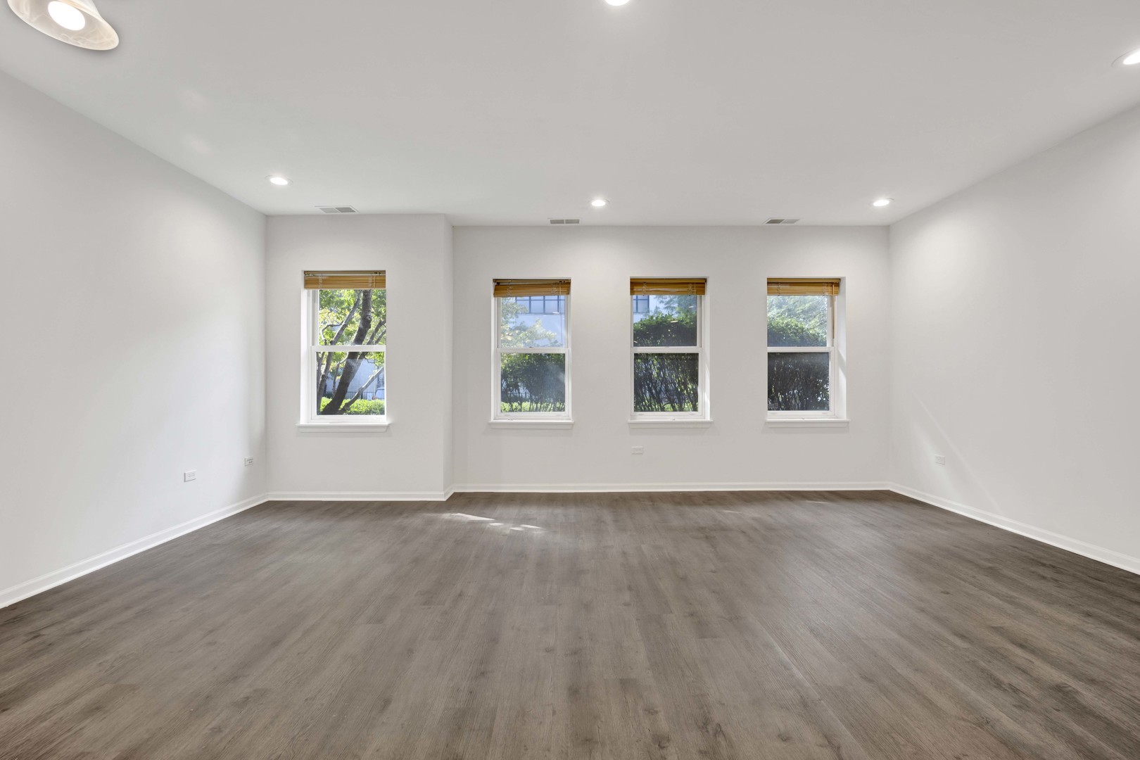 948 West 15th Place, Unit 1B Chicago, IL 60608 - Photo 2 of 59 a view of an empty room with wooden floor and window