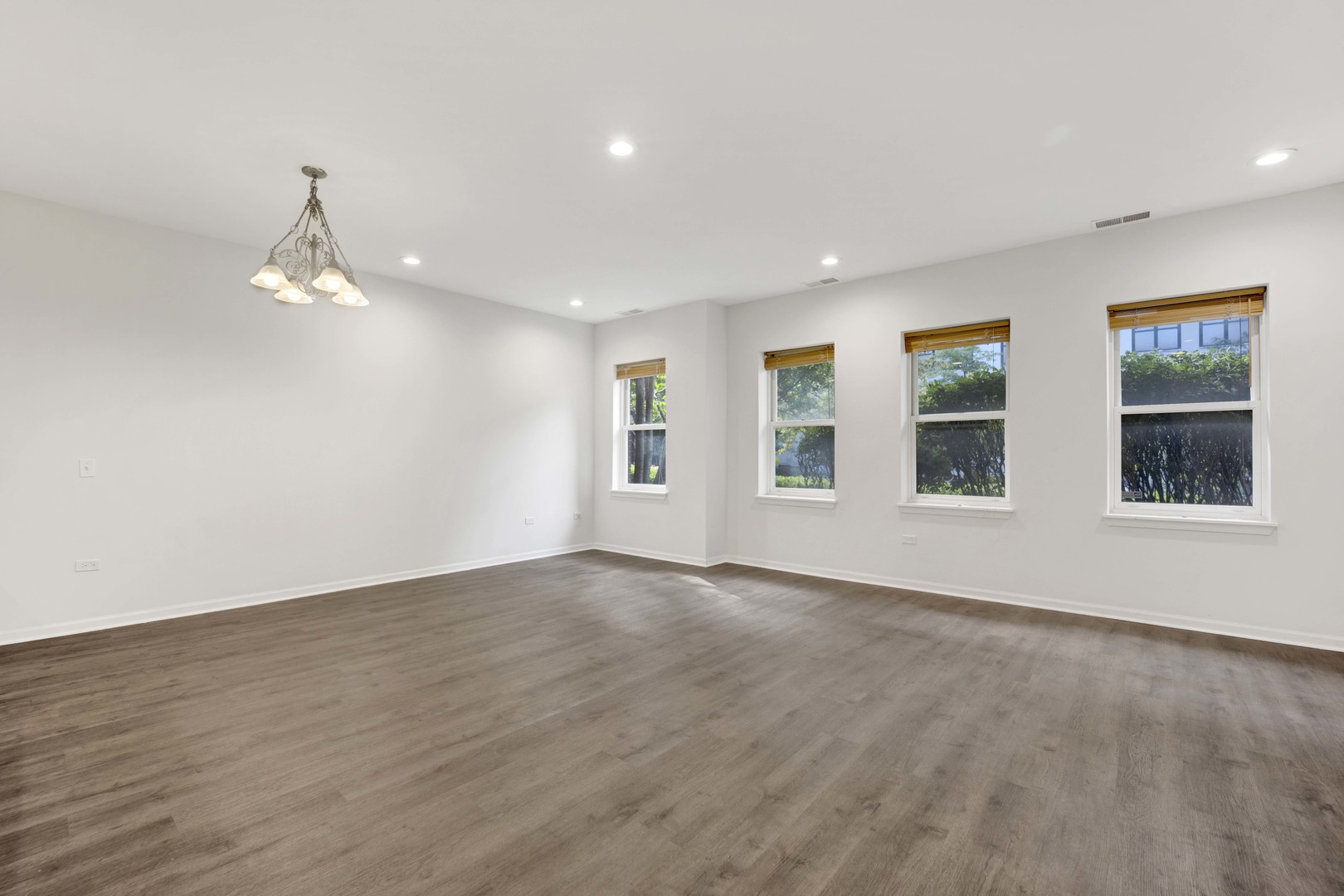 948 West 15th Place, Unit 1B Chicago, IL 60608 - Photo 3 of 59 a view of an empty room with wooden floor and a window
