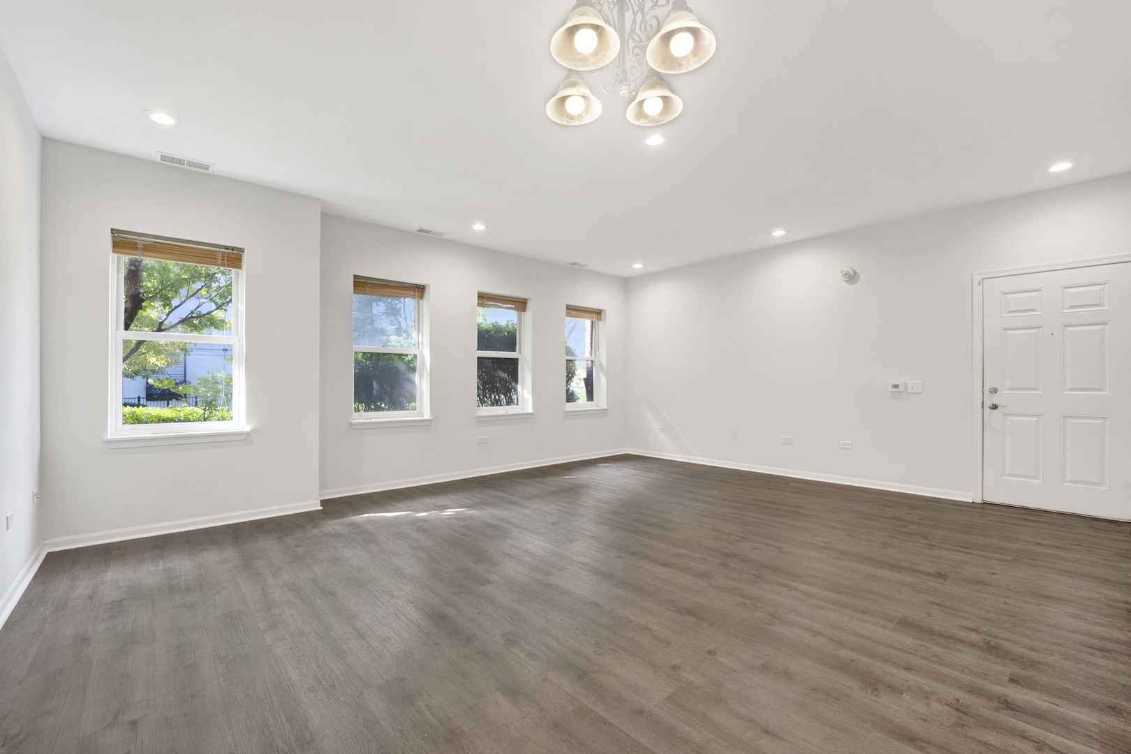 948 West 15th Place, Unit 1B Chicago, IL 60608 - Photo 4 of 59 an empty room with wooden floor and windows