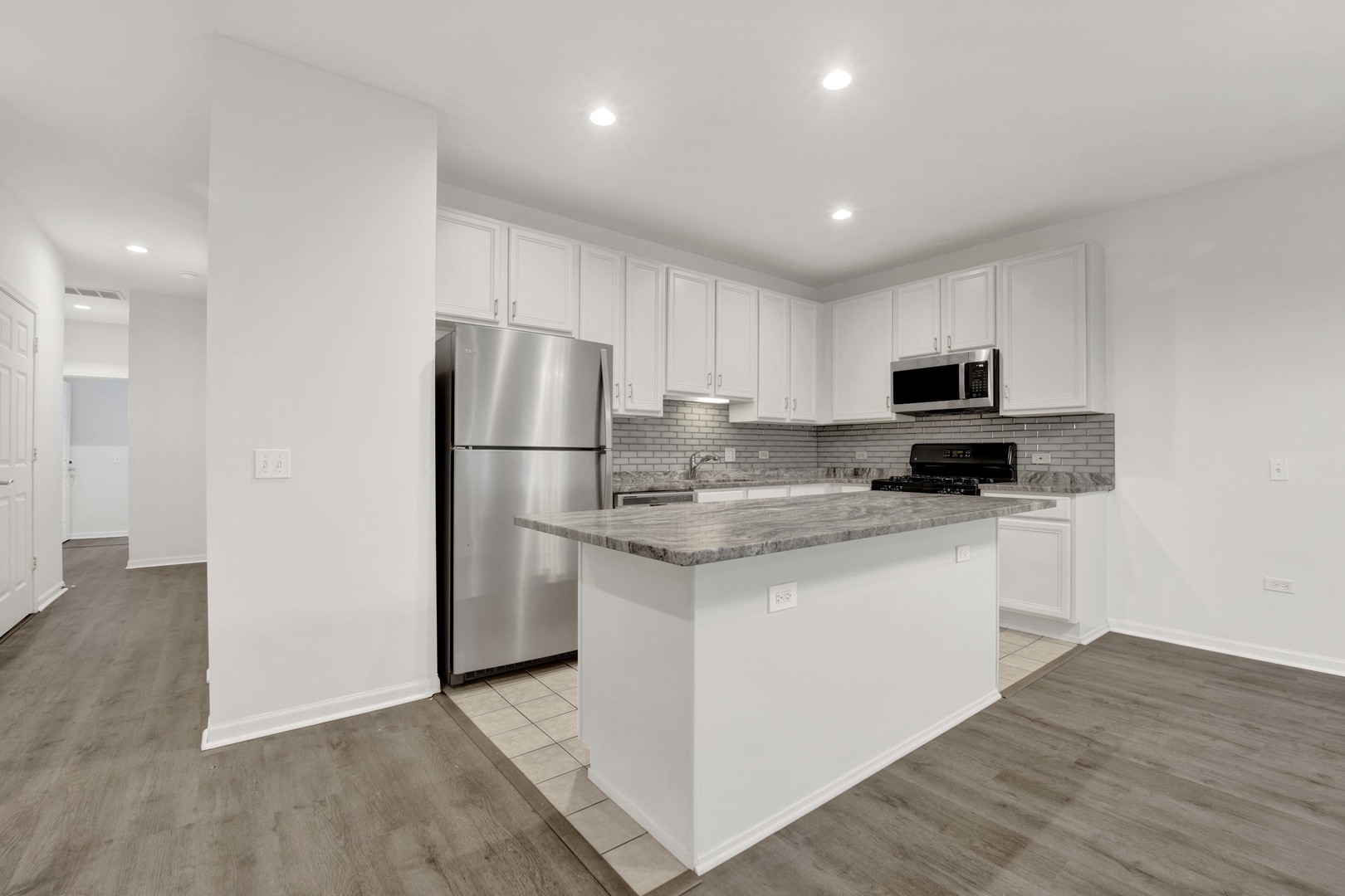 948 West 15th Place, Unit 1B Chicago, IL 60608 - Photo 6 of 59 a kitchen with stainless steel appliances granite countertop a refrigerator stove a sink and a microwave
