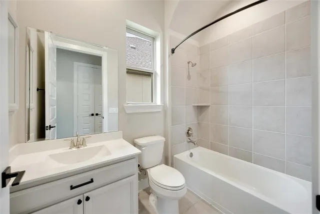 a bathroom with a sink toilet vanity and shower