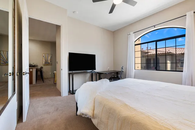 a bedroom with a bed and a flat screen tv