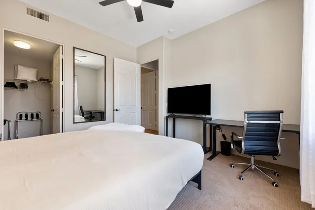 a bedroom with a bed and a flat screen tv