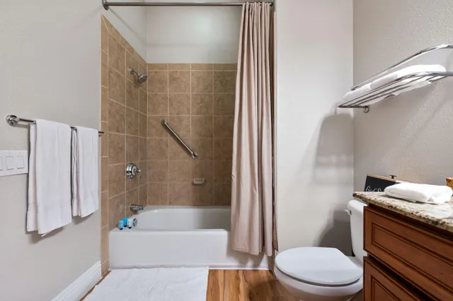 a white toilet sitting next to a bath tub shower