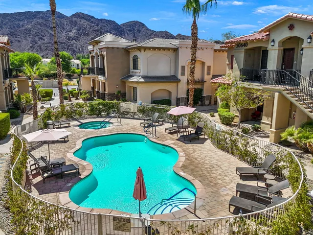 a view of a house with swimming pool and sitting area