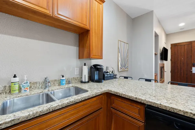a kitchen with stainless steel appliances granite countertop a sink and a counter space