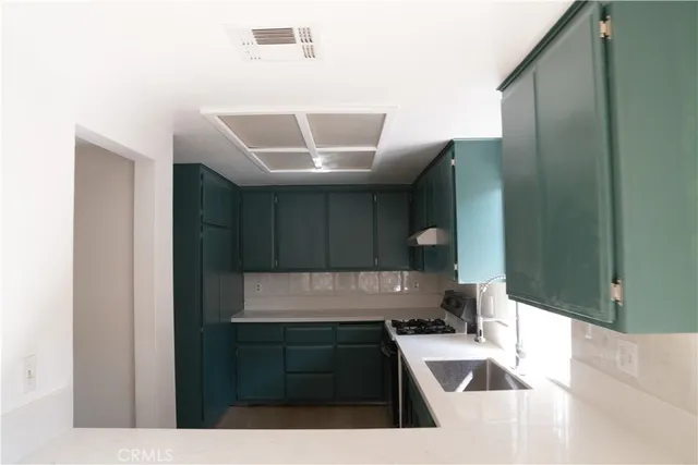 a kitchen with a sink and a refrigerator