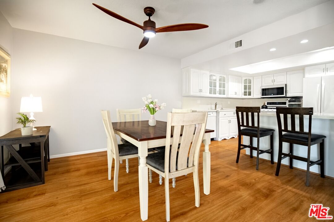 27003 Rio Prado Drive Valencia, CA 91354 - Photo 11 of 40 a view of a dining room with furniture and wooden floor