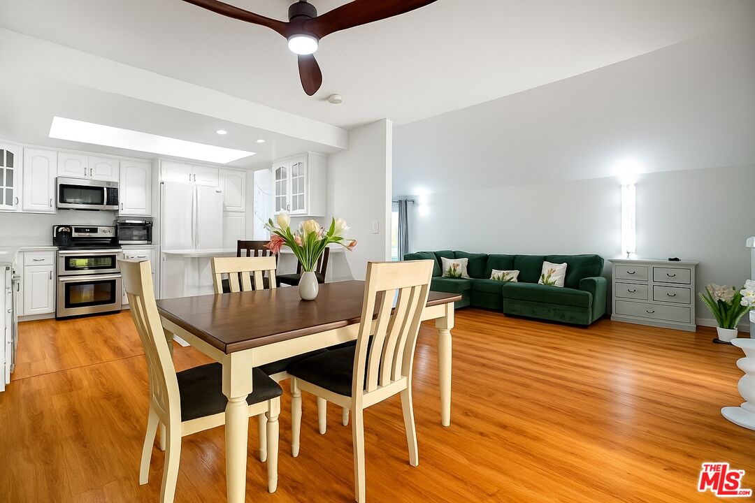27003 Rio Prado Drive Valencia, CA 91354 - Photo 12 of 40 a view of a dining room with furniture and wooden floor