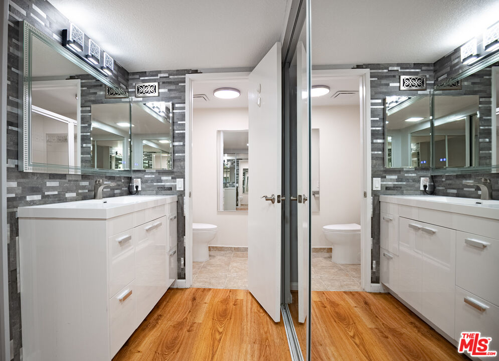 27003 Rio Prado Drive Valencia, CA 91354 - Photo 15 of 40 a spacious bathroom with a sink mirror and a shower