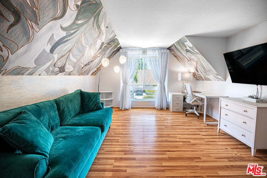 27003 Rio Prado Drive Valencia, CA 91354 - Photo 18 of 40 a living room with furniture cabinets and a flat screen tv