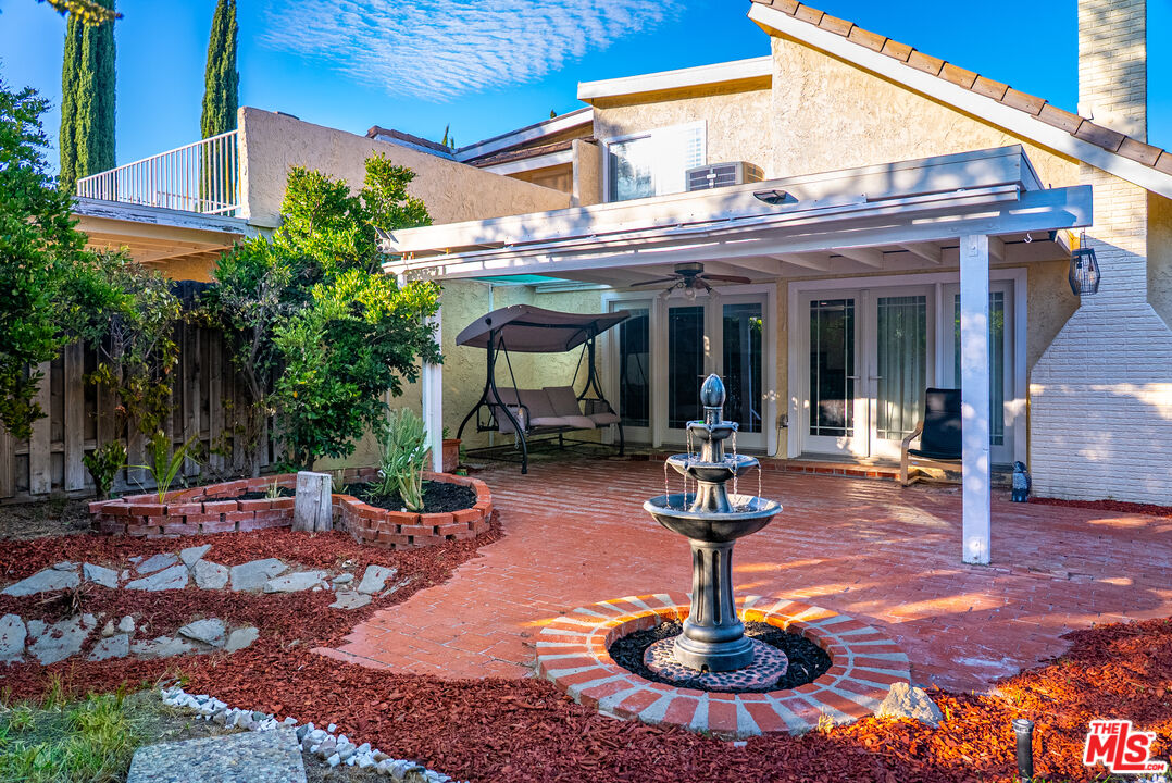 27003 Rio Prado Drive Valencia, CA 91354 - Photo 2 of 40 a view of a patio with table and chairs potted plants and a fountain