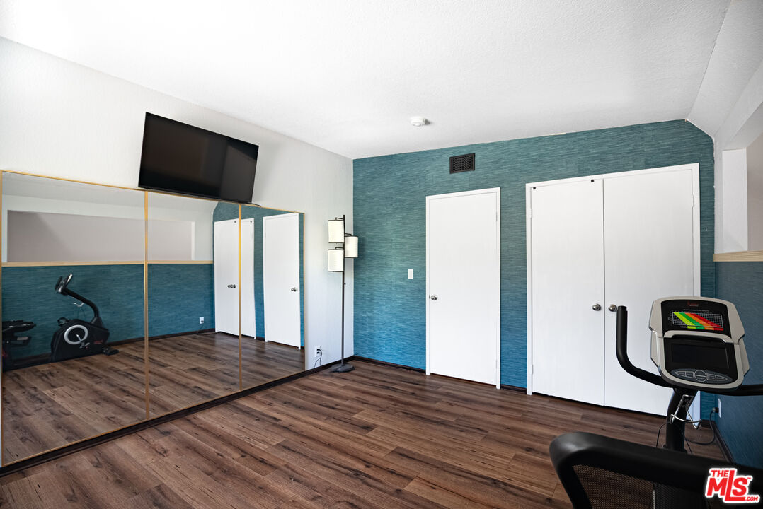 27003 Rio Prado Drive Valencia, CA 91354 - Photo 26 of 40 a bedroom with a bed and a flat screen tv