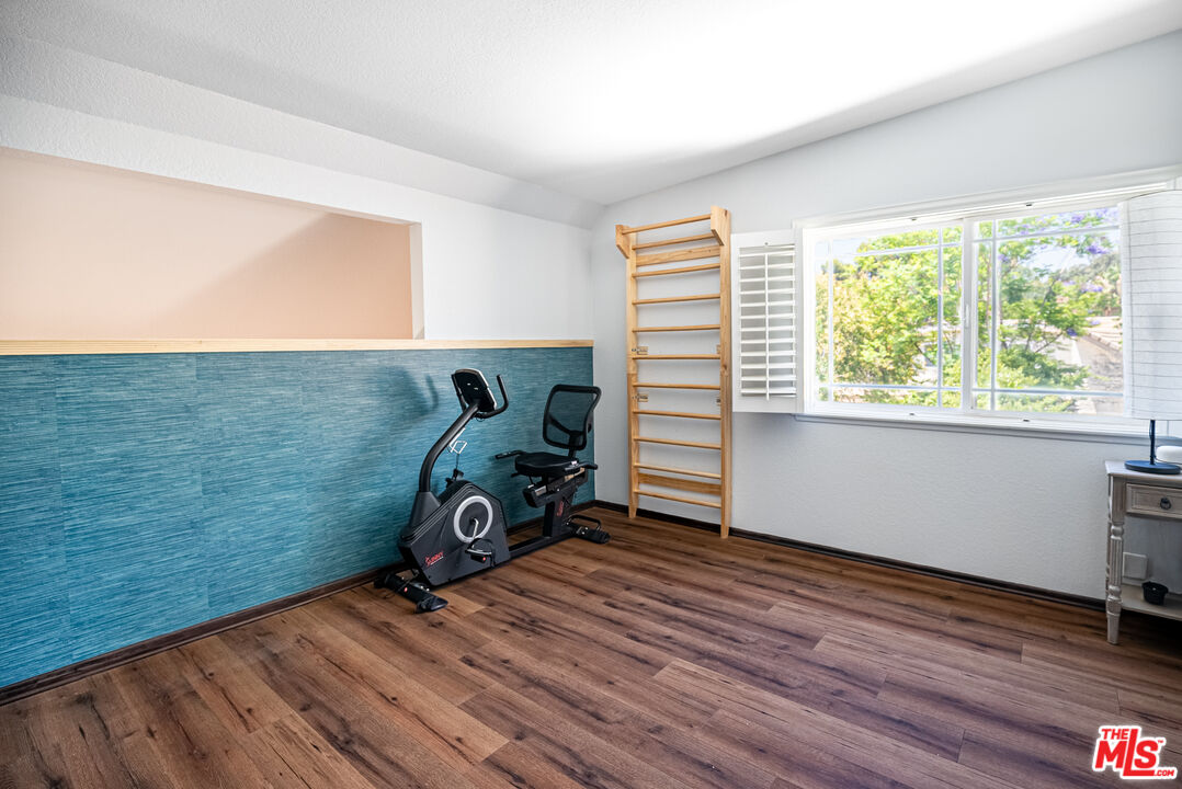 27003 Rio Prado Drive Valencia, CA 91354 - Photo 28 of 40 a view of a room with gym equipment and wooden floor