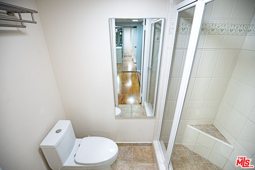 27003 Rio Prado Drive Valencia, CA 91354 - Photo 29 of 40 a white toilet sitting next to a shower