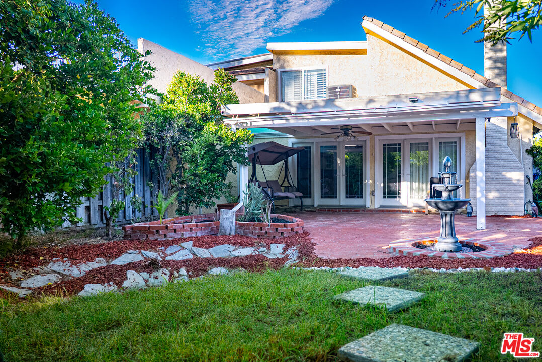 27003 Rio Prado Drive Valencia, CA 91354 - Photo 31 of 40 a view of a backyard with table and chairs and wooden fence