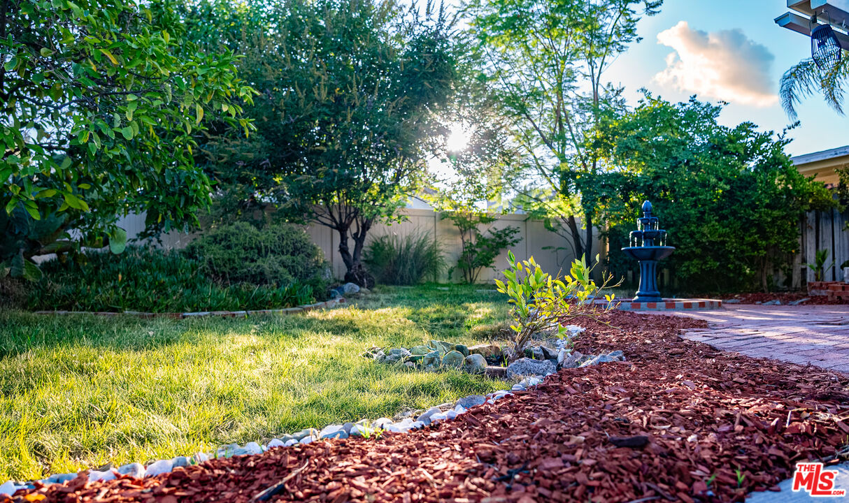 27003 Rio Prado Drive Valencia, CA 91354 - Photo 37 of 40 a view of a garden with plants and large trees