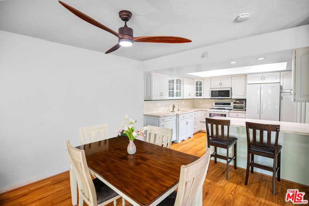 27003 Rio Prado Drive Valencia, CA 91354 - Photo 10 of 40 a view of a dining room with furniture and wooden floor