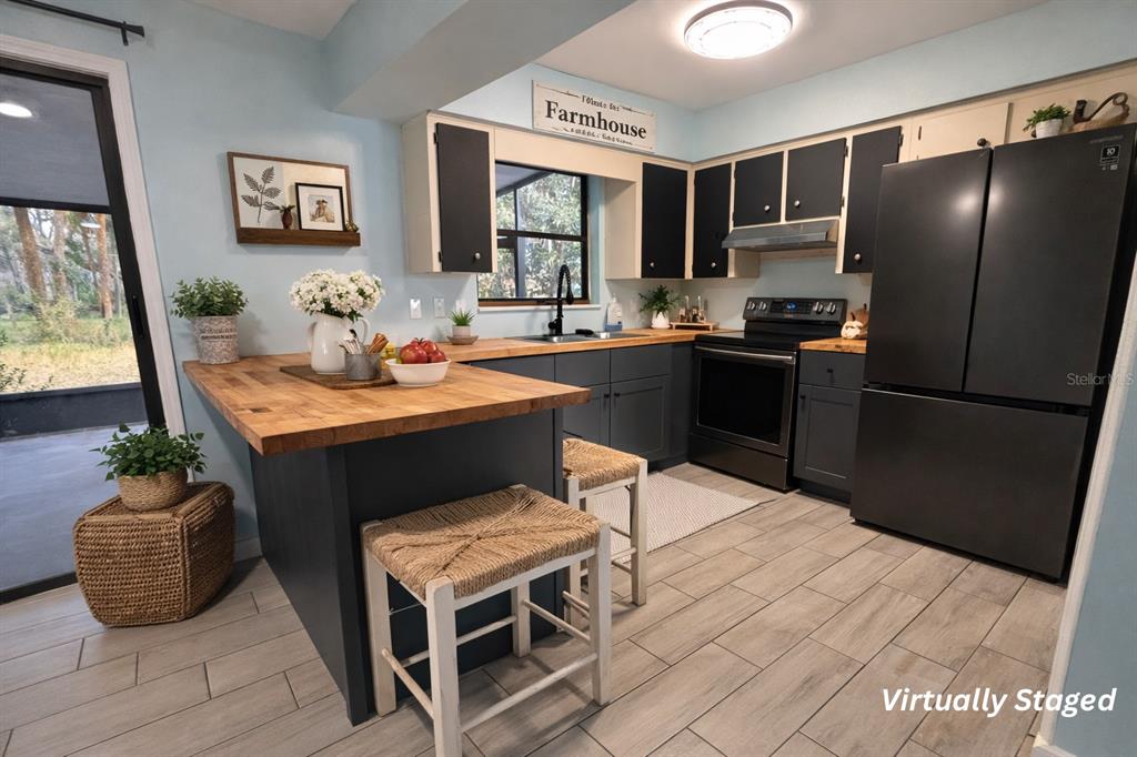5028 Ralston Road Lakeland, FL 33811 - Photo 22 of 29 a kitchen with a sink and a refrigerator