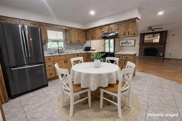 a dining room with furniture a window and kitchen view