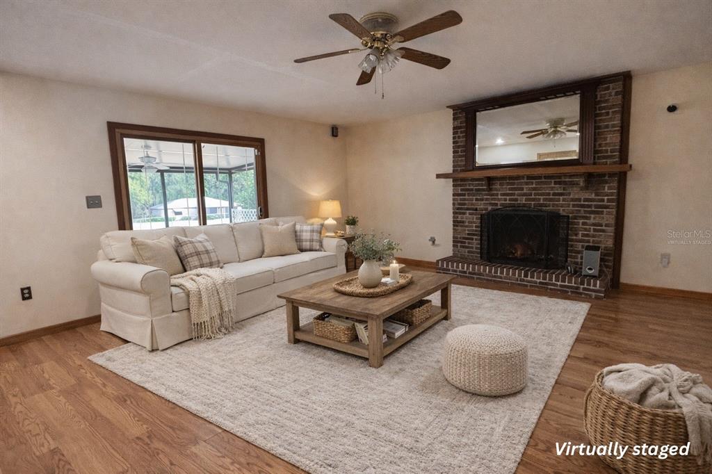 5028 Ralston Road Lakeland, FL 33811 - Photo 6 of 29 a living room with furniture a fireplace and a large window