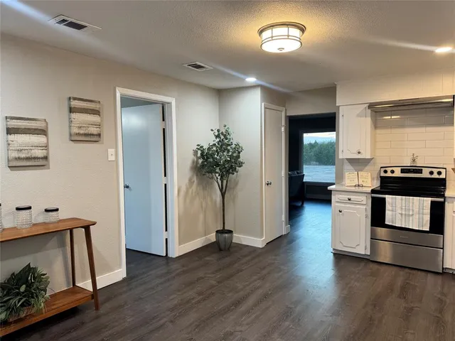 a kitchen with a refrigerator and a stove