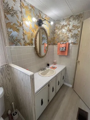 a bathroom with a double vanity sink and a mirror