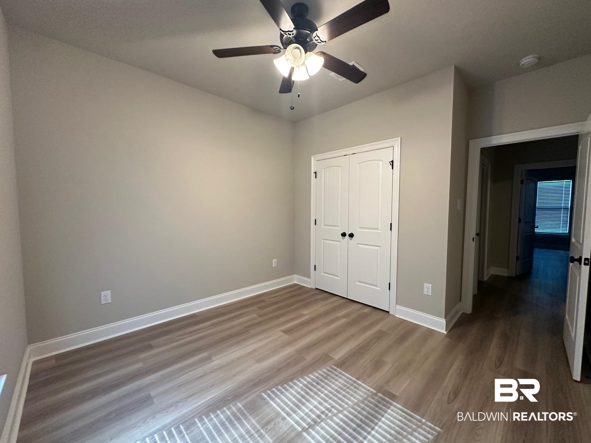 1009 Ruisseau Drive Foley, AL 36535 - Photo 51 of 55 Unfurnished bedroom with a closet, ceiling fan, and wood-type flooring
