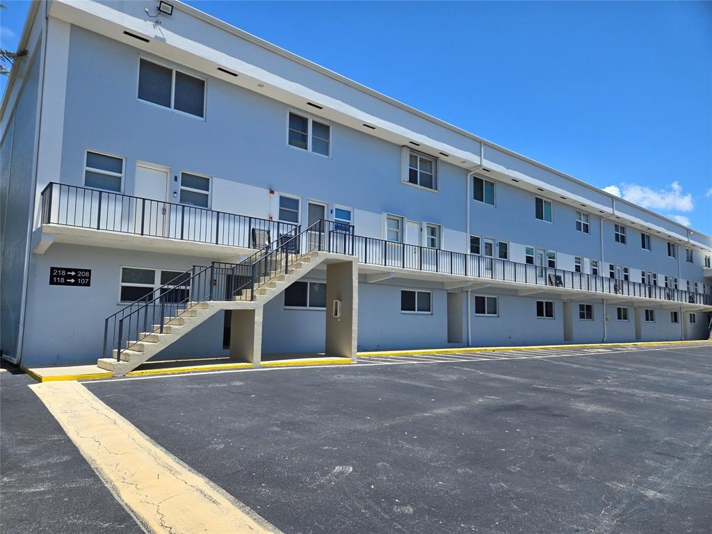 505 Northeast 20th Avenue, Unit 118 Deerfield Beach, FL 33441 - Photo 13 of 22 a front view of a building with yellow lighting