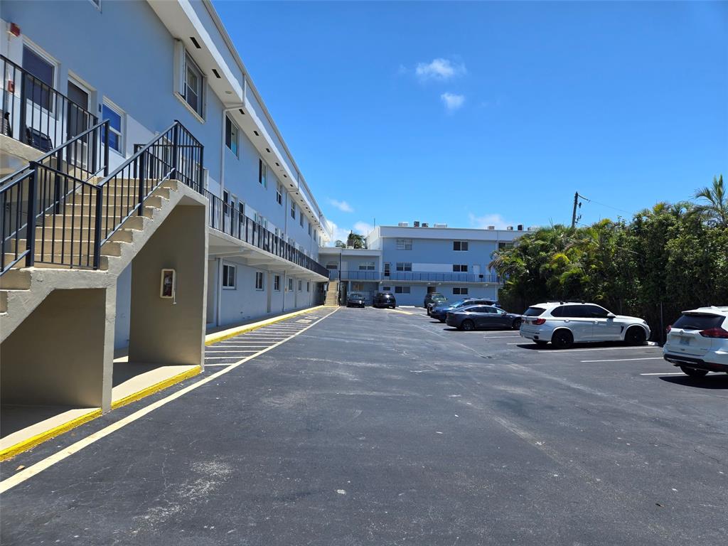 505 Northeast 20th Avenue, Unit 118 Deerfield Beach, FL 33441 - Photo 15 of 22 a view of street with parked cars