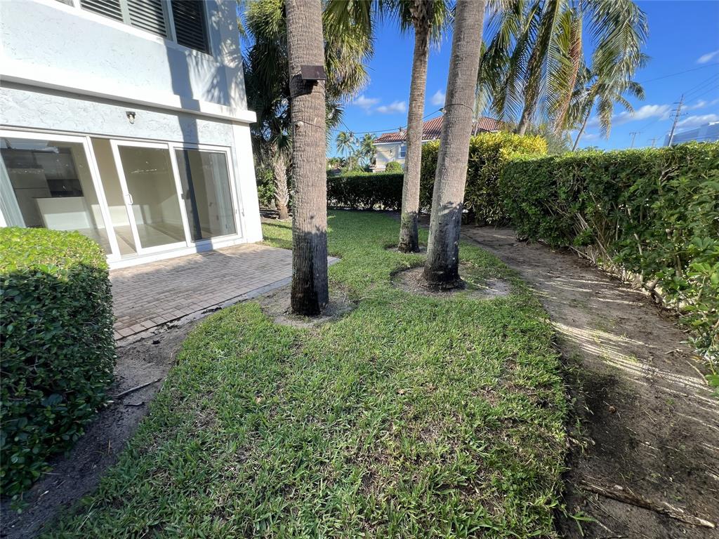 505 Northeast 20th Avenue, Unit 118 Deerfield Beach, FL 33441 - Photo 20 of 22 a house that has a tree in front of it