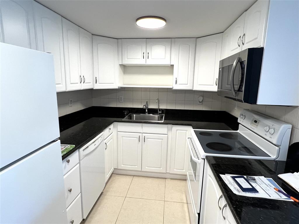 505 Northeast 20th Avenue, Unit 118 Deerfield Beach, FL 33441 - Photo 2 of 22 a kitchen with a sink and cabinets