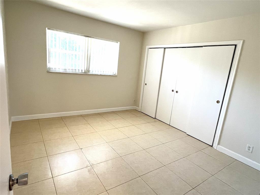 505 Northeast 20th Avenue, Unit 118 Deerfield Beach, FL 33441 - Photo 4 of 22 a view of an empty room with a window