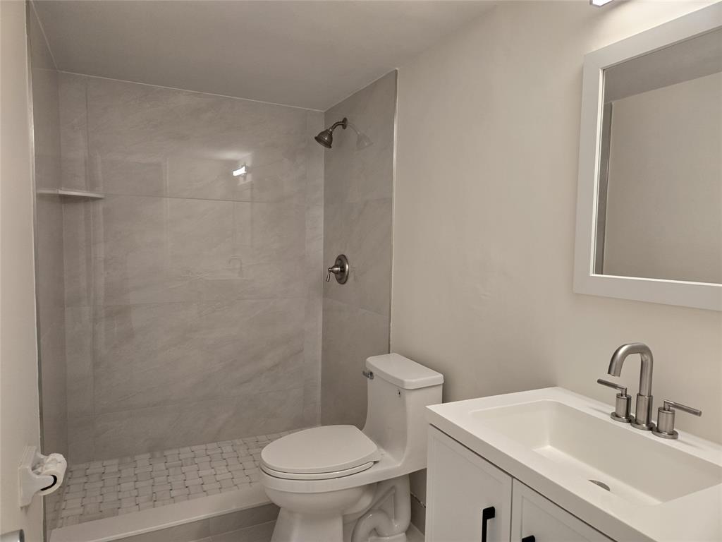 505 Northeast 20th Avenue, Unit 118 Deerfield Beach, FL 33441 - Photo 7 of 22 a bathroom with a sink toilet and shower