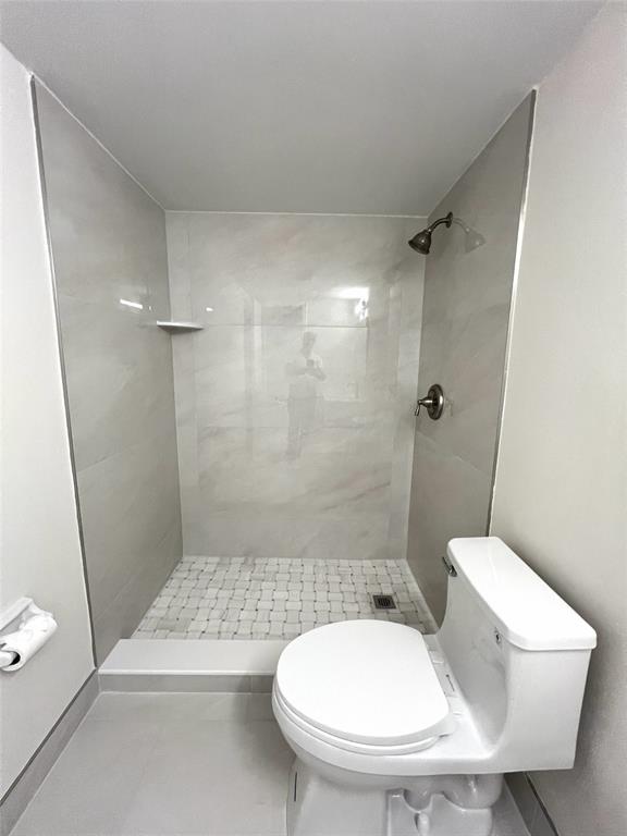 505 Northeast 20th Avenue, Unit 118 Deerfield Beach, FL 33441 - Photo 9 of 22 a bathroom with a toilet and a shower