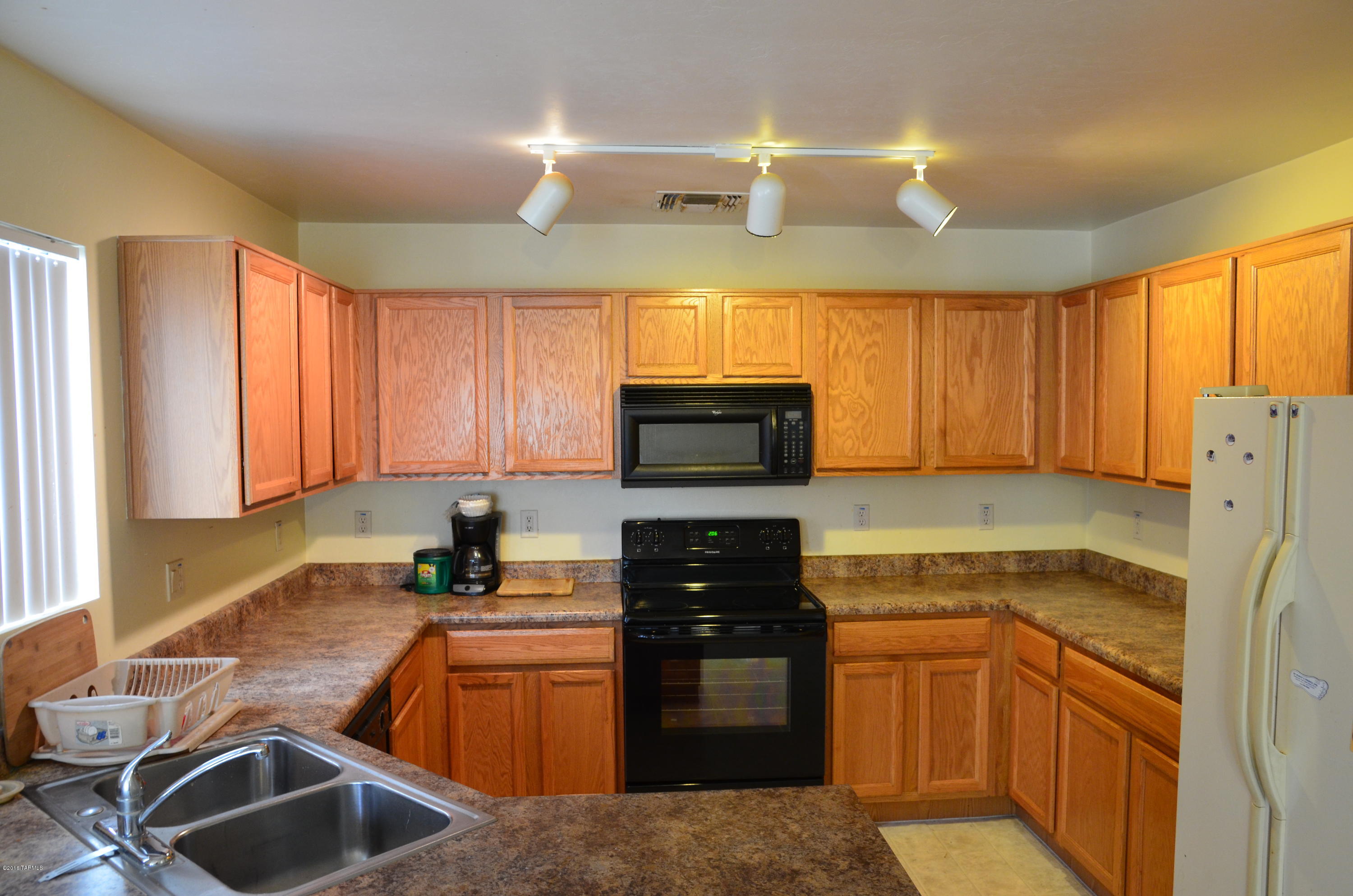 698 West Ash Ridge Drive Green Valley, AZ 85614 - Photo 6 of 19 a kitchen with granite countertop a sink stainless steel appliances and cabinets