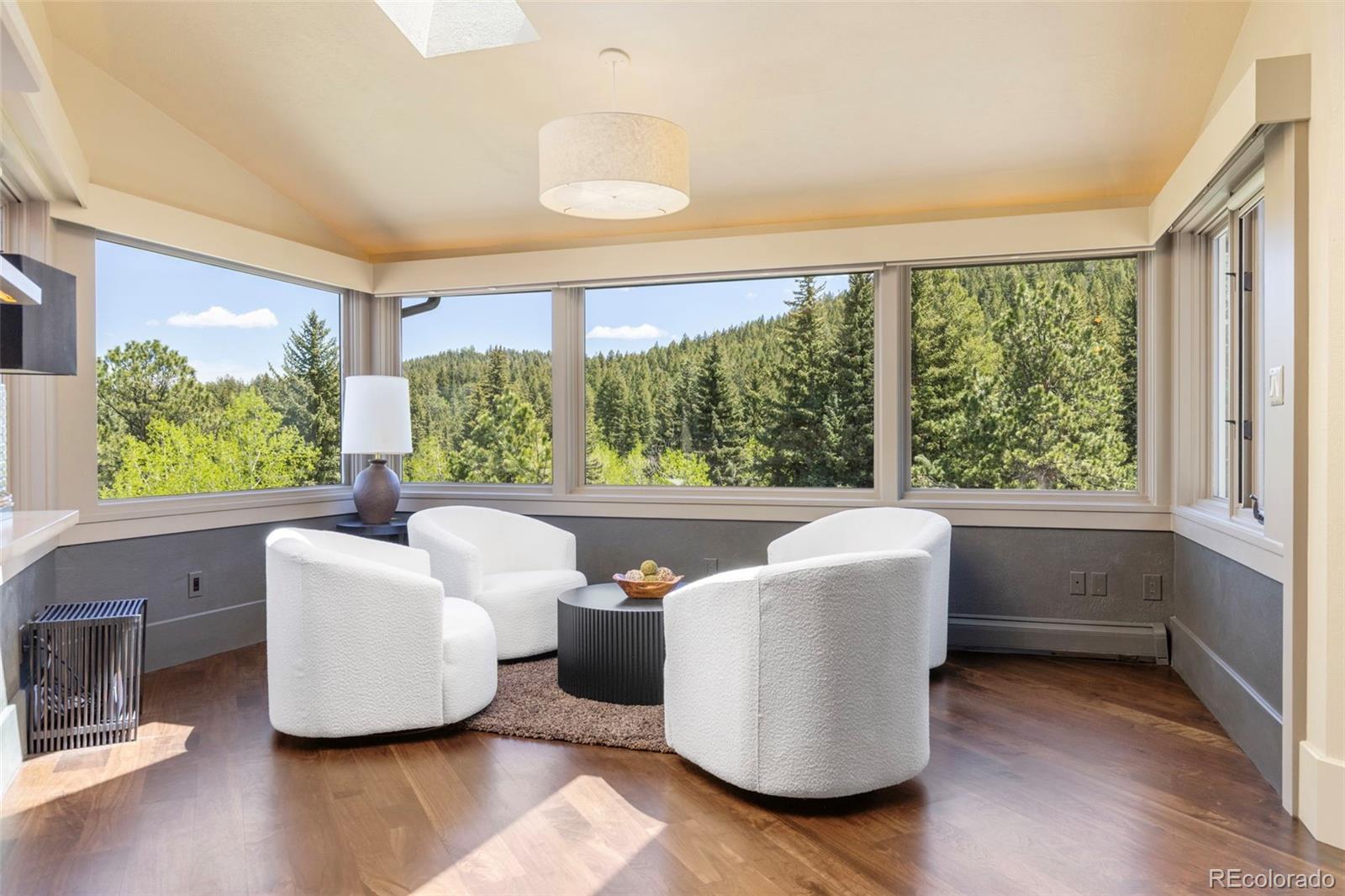 1323 South Snyder Gulch Road Evergreen, CO 80439 - Photo 6 of 47 a living room with furniture and a large window
