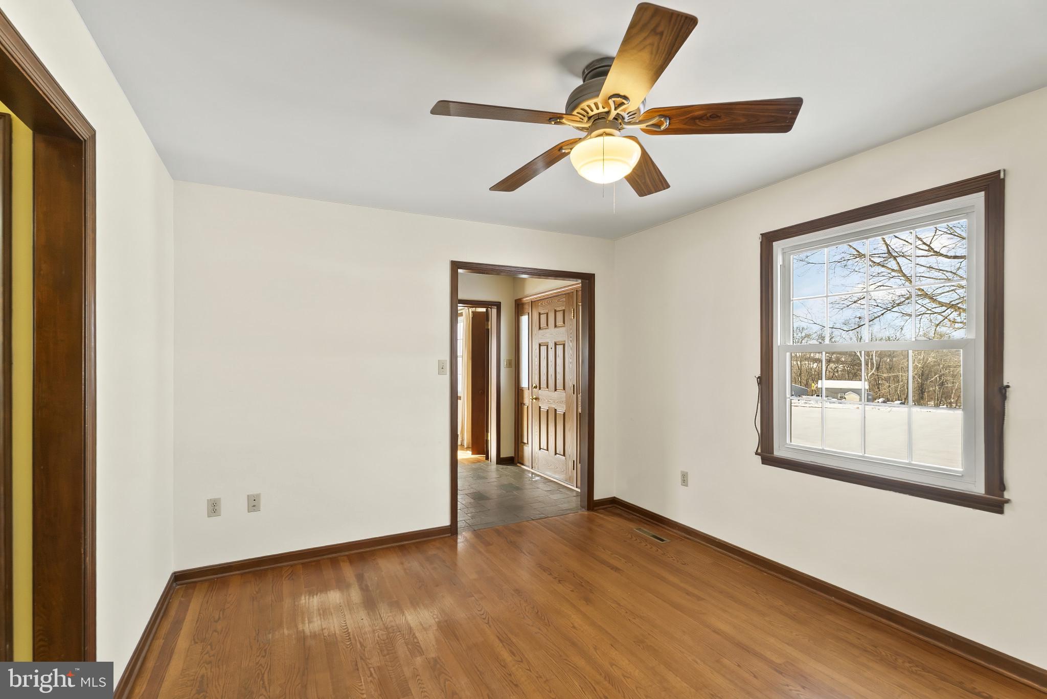7823 Timmons Road Mount Airy, MD 21771 - Photo 11 of 38 a view of an empty room with wooden floor and a window