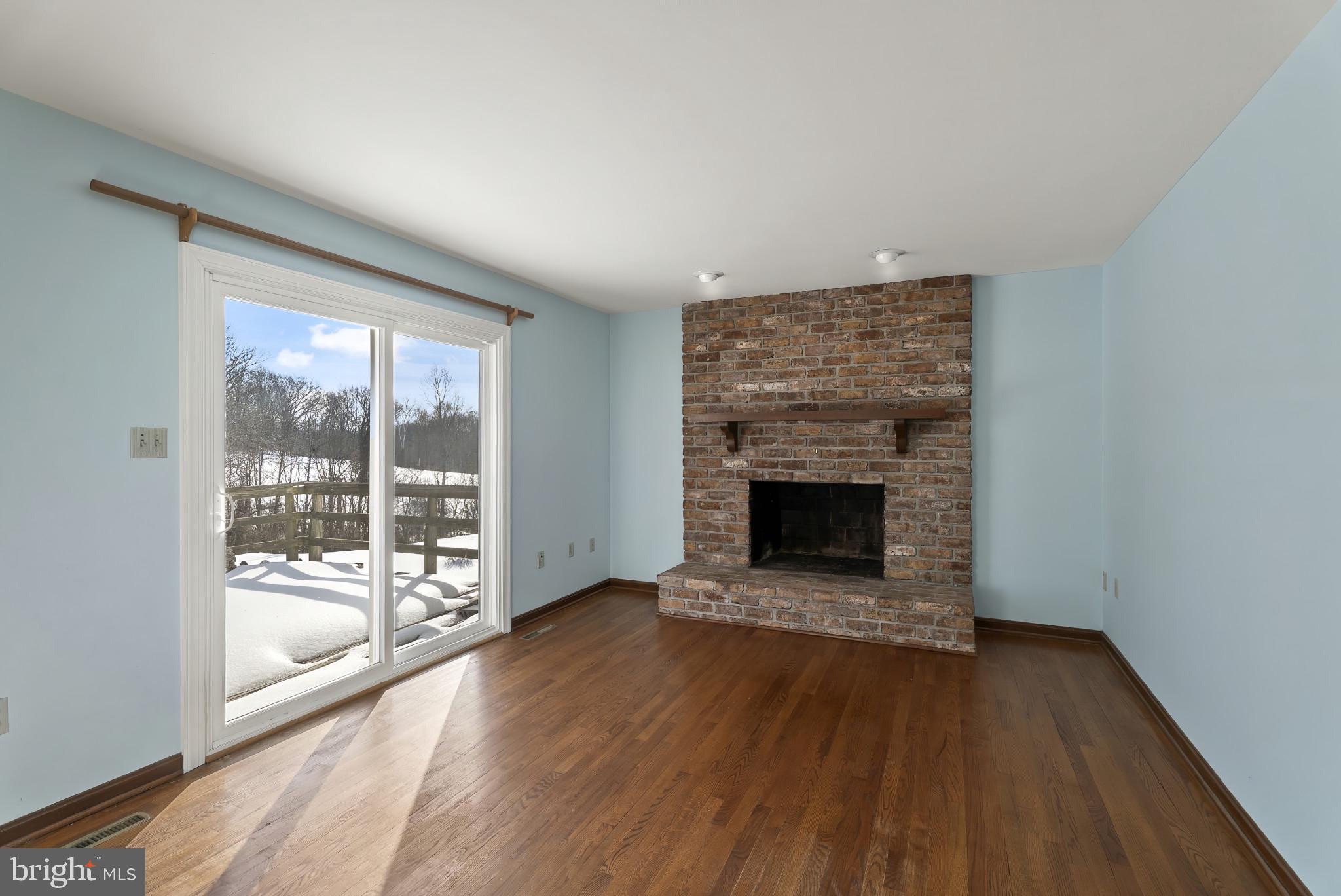 7823 Timmons Road Mount Airy, MD 21771 - Photo 12 of 38 wooden floor fireplace and natural light in room