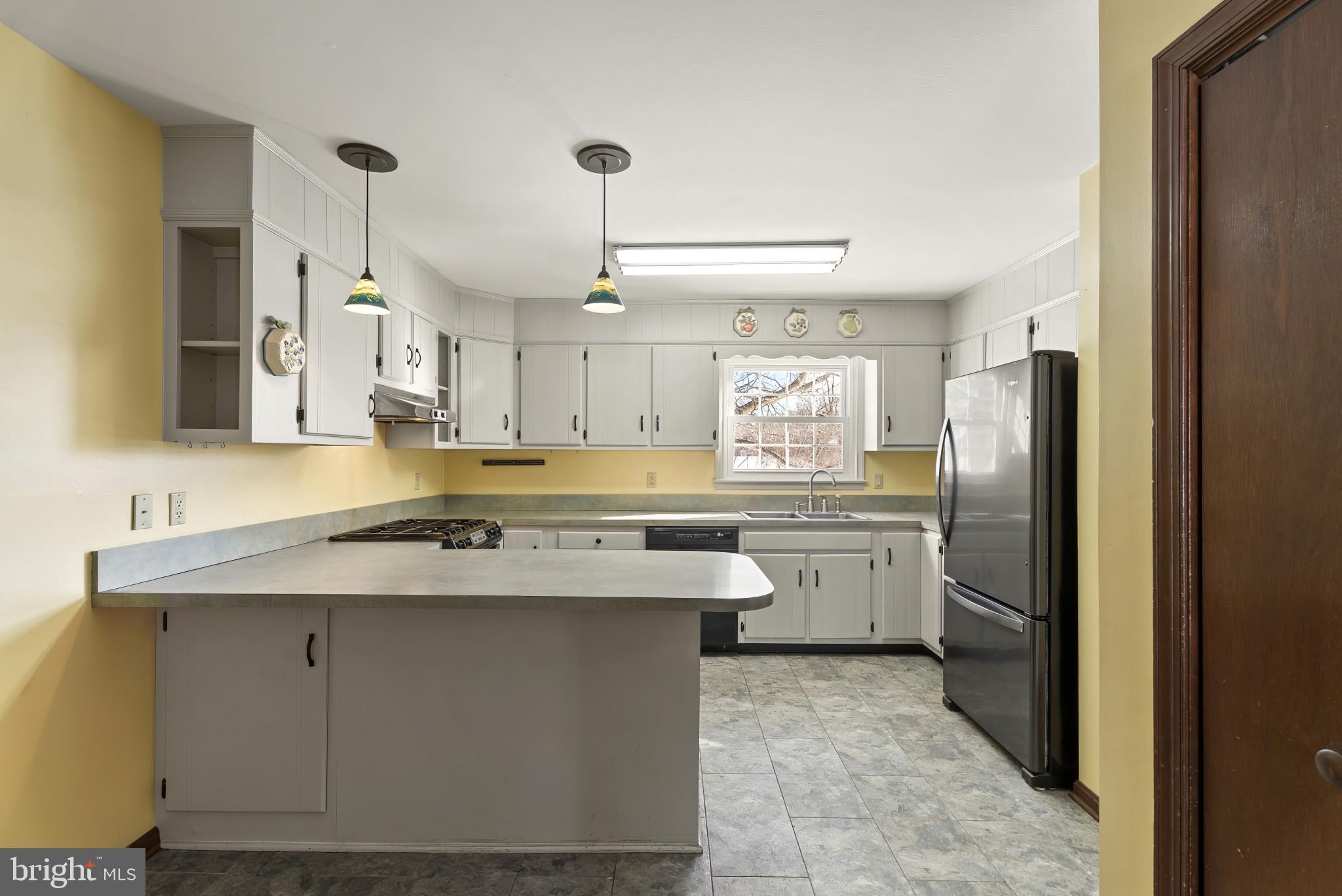 7823 Timmons Road Mount Airy, MD 21771 - Photo 15 of 38 a kitchen with a sink refrigerator and cabinets