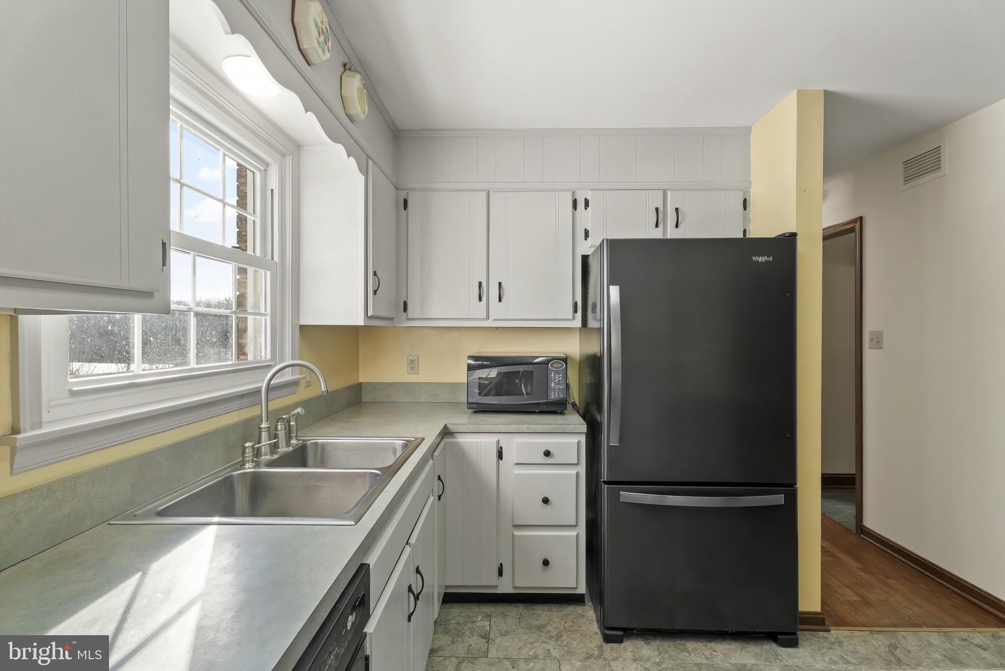 7823 Timmons Road Mount Airy, MD 21771 - Photo 17 of 38 a kitchen with a refrigerator sink and cabinets