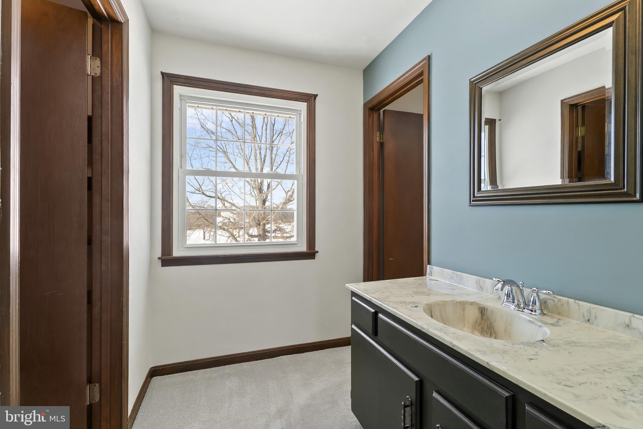 7823 Timmons Road Mount Airy, MD 21771 - Photo 22 of 38 a bathroom with a granite countertop sink and a window