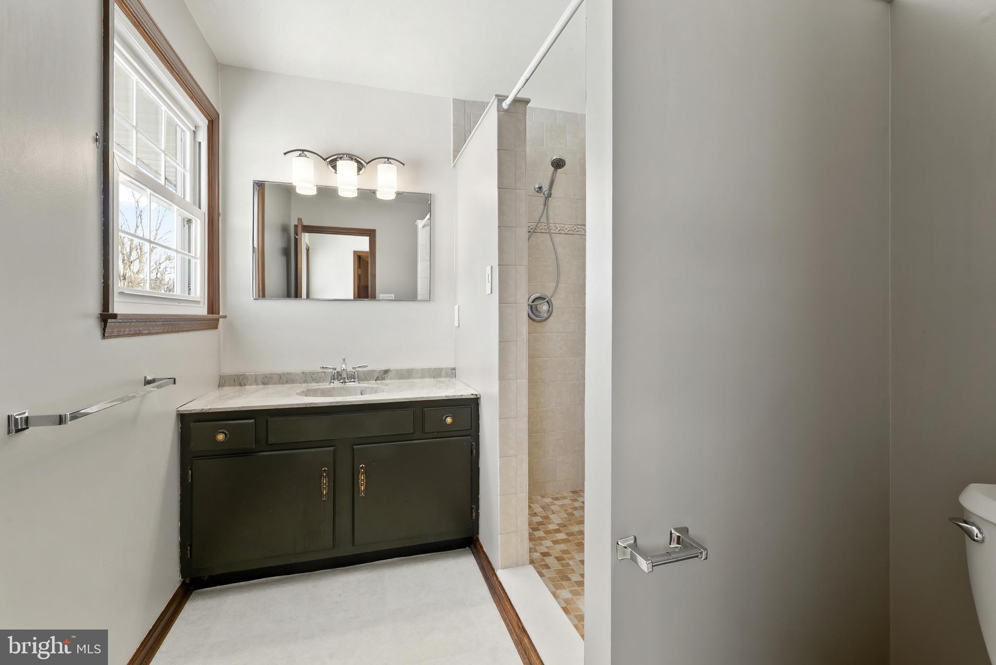 7823 Timmons Road Mount Airy, MD 21771 - Photo 23 of 38 a spacious bathroom with a granite countertop sink a mirror and a bathtub
