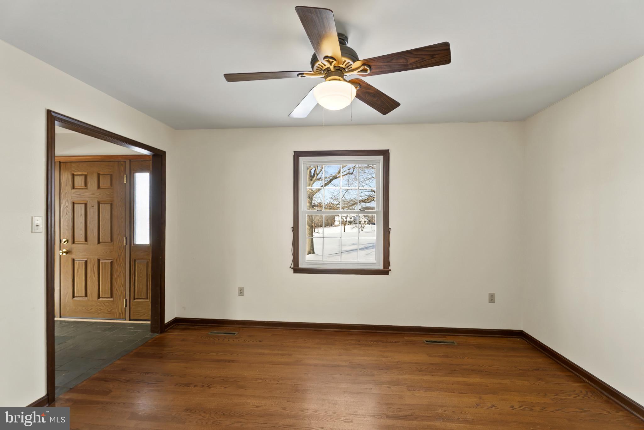 7823 Timmons Road Mount Airy, MD 21771 - Photo 10 of 38 a view of an empty room with window and wooden floor