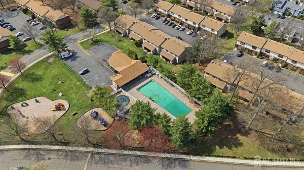 an aerial view of a house with garden space and street view