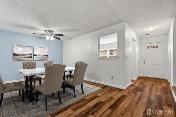 a view of a dining room with furniture window and wooden floor