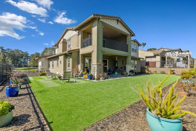 a view of a house with backyard porch and sitting area