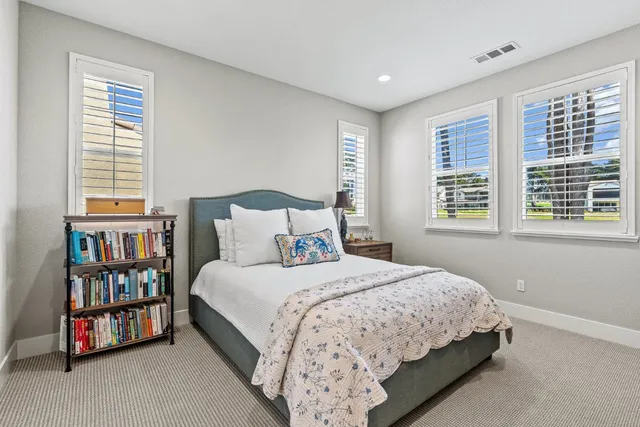 a bedroom with a bed furniture and a book shelf