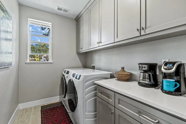 a utility room with sink dryer and washer